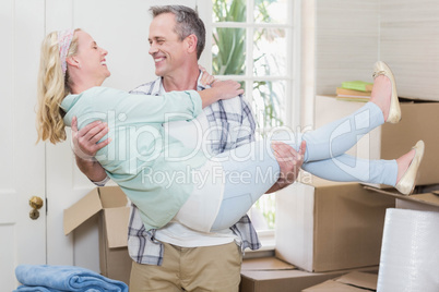 Happy husband carrying his wife