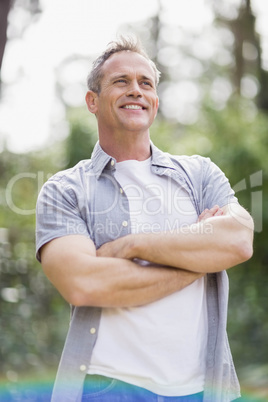 Smiling man crossing his arms