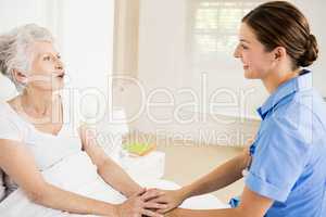 Nurse taking care of suffering senior patient