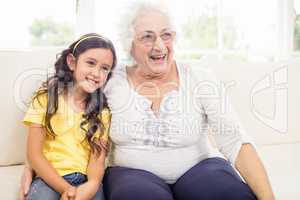 Happy grandmother and granddaughter smiling