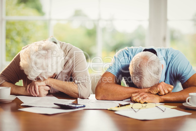 Senior couple with heads on arms