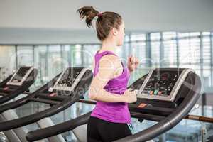 Fit woman running on treadmill
