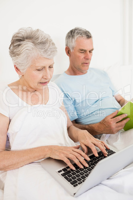 Relaxed senior couple at bed Relaxed senior couple at bed