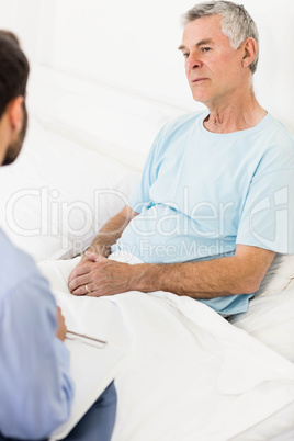 Handsome nurse visiting a mature man