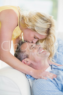 Wife kissing husband on the forehead