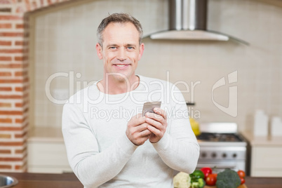 Handsome man looking at smartphone