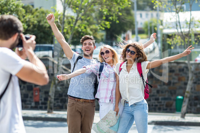 Hip man taking picture of his friends