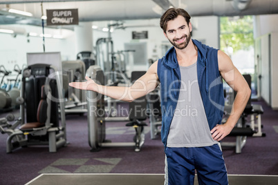 Smiling man showing the gym