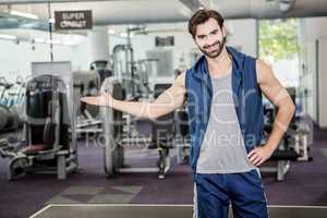 Smiling man showing the gym