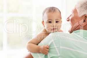 Senior man playing with his grandson