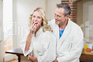 Cute couple cuddling in bathrobes