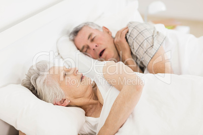Awake senior woman in bed