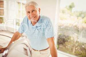 Senior man standing and looking at the camera