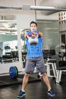 Handsome man lifting kettlebell