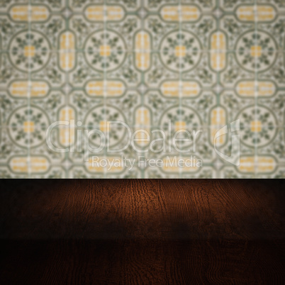 Wood table top and blur vintage ceramic tile pattern wall
