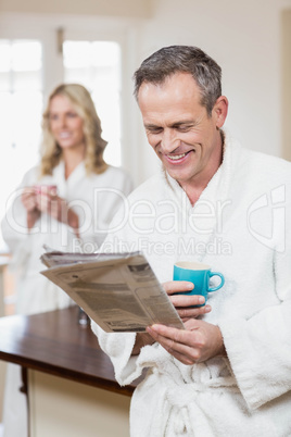 Cute couple having coffee and reading news