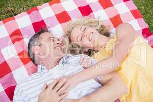 Happy couple hugging on a blanket