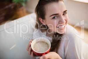 Pretty woman relaxing on couch with coffee