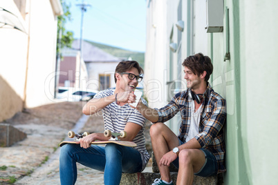 Hip men sitting on steps