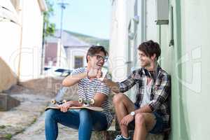 Hip men sitting on steps