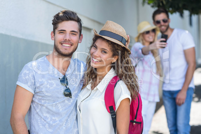 Hip couple smiling at the camera