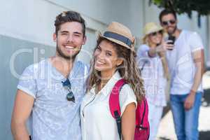 Hip couple smiling at the camera