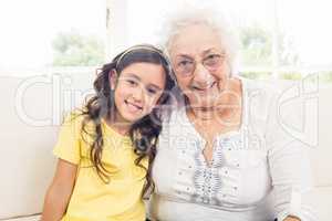 Grandmother and granddaughter smiling