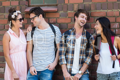 Hip friends leaning against wall