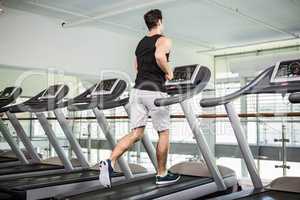 Fit man running on treadmill