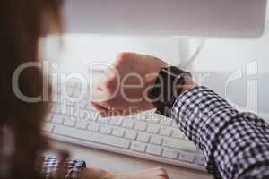 Over the shoulder view of businesswoman watching her smart watch