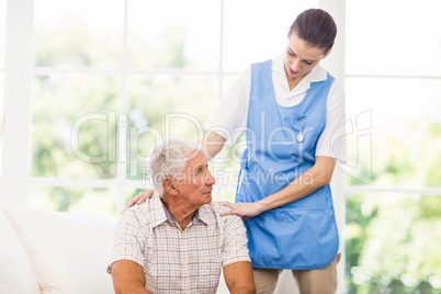 Nurse taking care of sick elderly patient