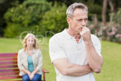 Thoughtful man with girlfriend sitting behind