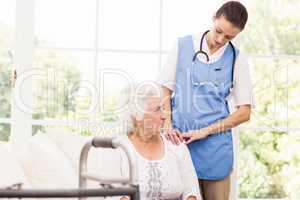 Nurse taking care of sick elderly woman