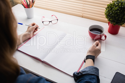 Casual businesswoman working at her desk