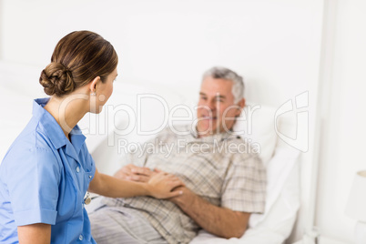 Nurse taking care of suffering senior patient