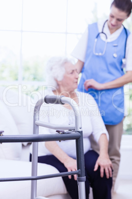 Nurse taking care of sick elderly woman