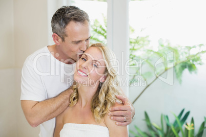 Husband kissing wife on the forehead