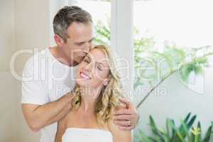 Husband kissing wife on the forehead