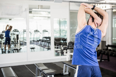 Muscular man doing stretching