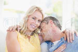 Happy couple hugging on the couch