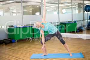 Fit woman doing yoga on mat