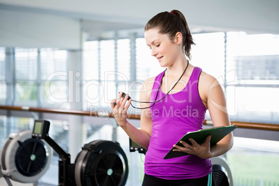 Smiling trainer looking at stopwatch