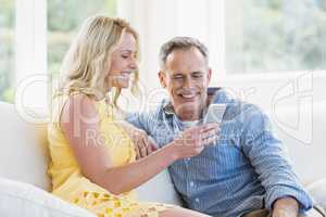 Happy couple using smartphone