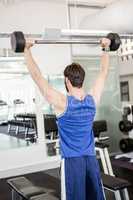 Muscular man lifting barbell