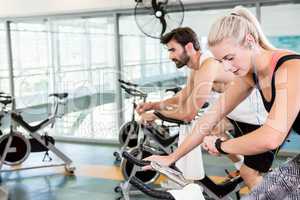 Fit couple using exercise bikes