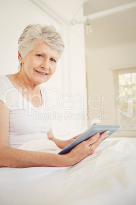 Smiling woman using tablet