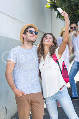 Hip couple taking selfie