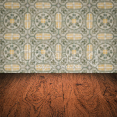 Wood table top and blur vintage ceramic tile pattern wall