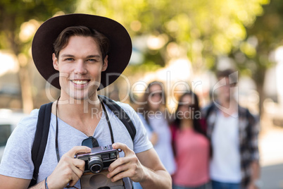 Hip man holding digital camera