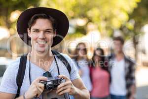 Hip man holding digital camera